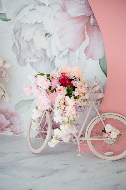 Bike Covered In Flowers Leans Against A Floral Wall Photo