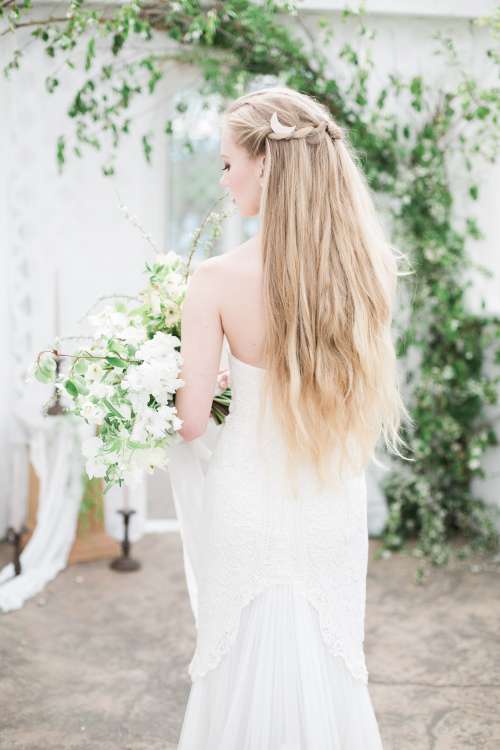 Blond Person In A White Dress Holds A Large Bouquet Of Flowers Photo