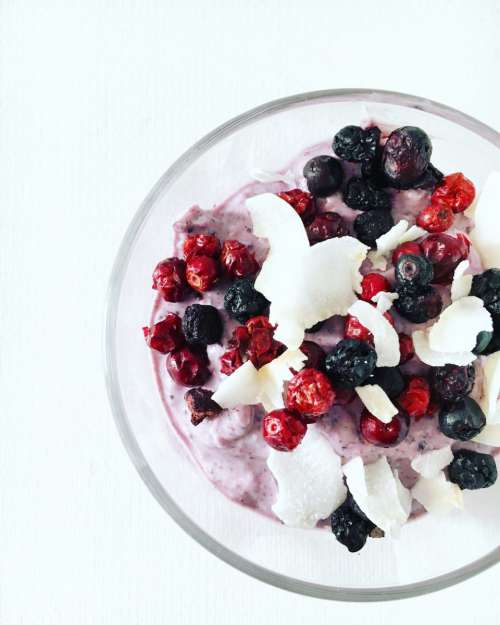 Breakfast bowl with berries and coconut flakes
