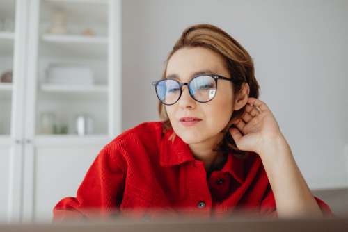 A woman works at a desk in her home