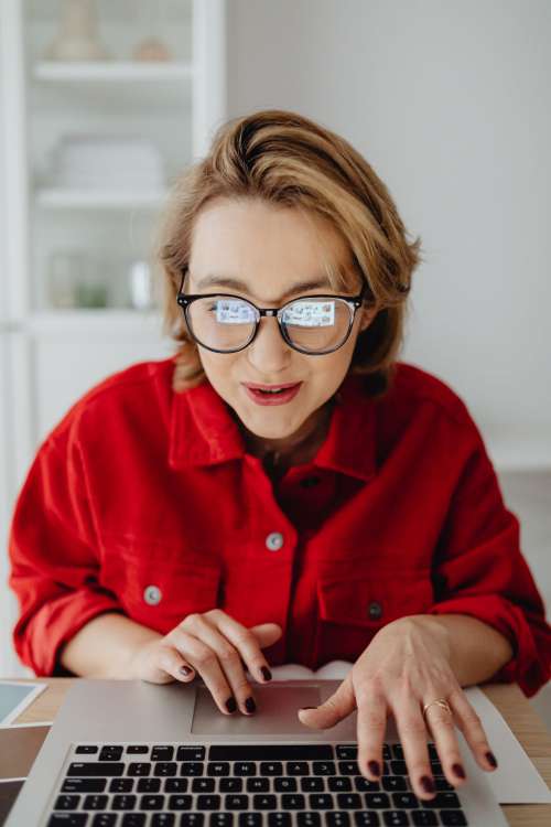 A woman works at a desk in her home