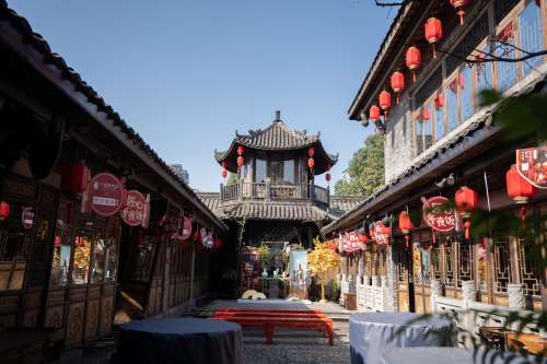 An Open Courtyard With Red Lanterns At Each Doorway Photo