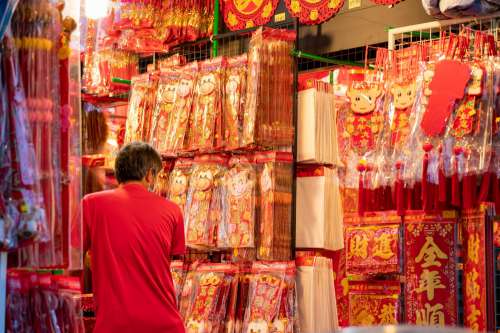 Person Shops In A Store Selling Red And Gold Decorations Photo