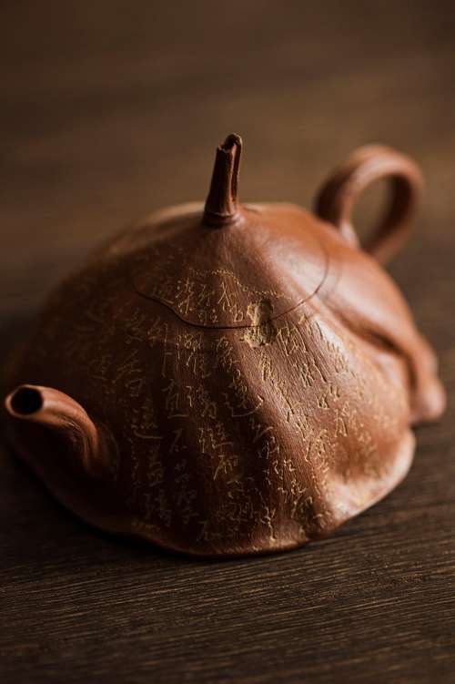 Unique Metal Teapot Sits On A Wooden Surface Photo