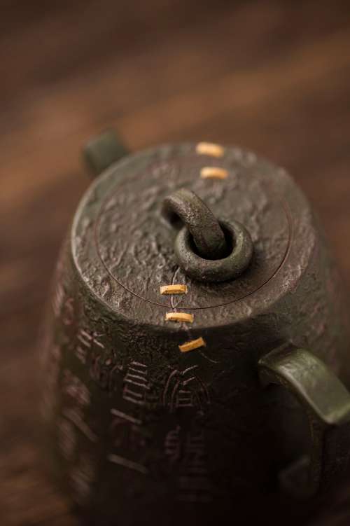 Close Up Of A Metal Teapot WIth Gold Lines Photo
