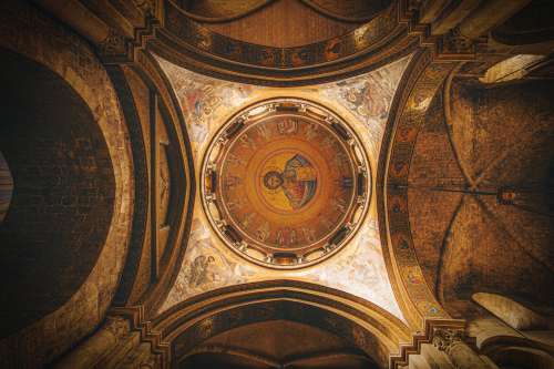 Painted Ceiling In A Church With Stone Archways Photo