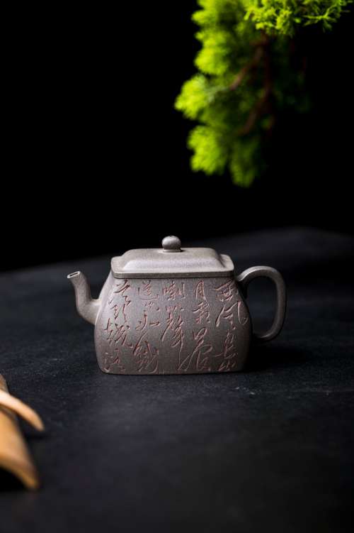 Square Teapot With A Cedar Branch Above Photo