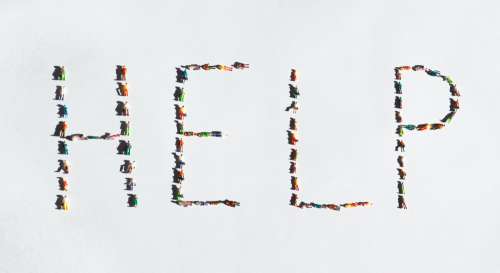 The Word Help Spelled Out With Plastic Miniatures Photo