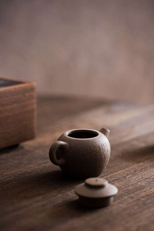 Tiny Teapot Sits With The Lid Off On A Wooden Table Photo