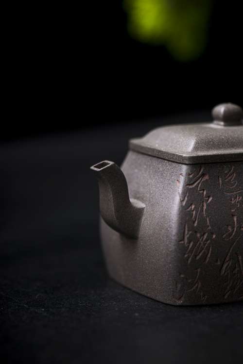 A Close Up View Of A Grey Teapot With A Square Spout Photo