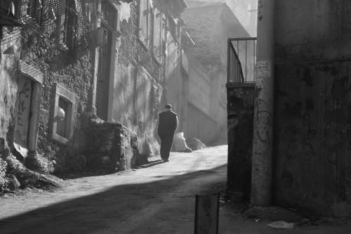 Urban View Of A Person Walking In Black And White Photo