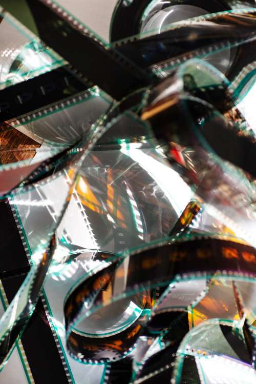 Film Reel Catches Light Tangled On A White Surface Photo