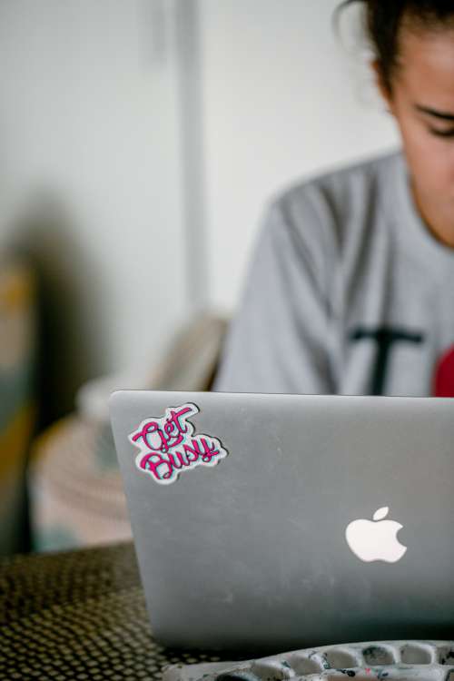 Silver Laptop With A Pink Sticker Thats Says Get Busy Photo