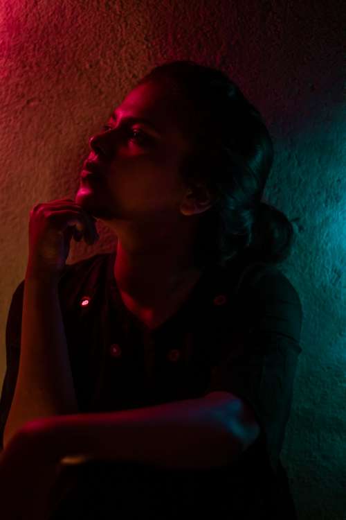 Person In Thought In Pink And Blue Light Photo