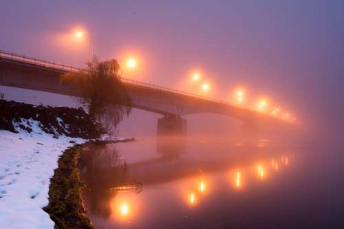 A Bridge With Yellow Lights Blurred By Thick Fog Photo