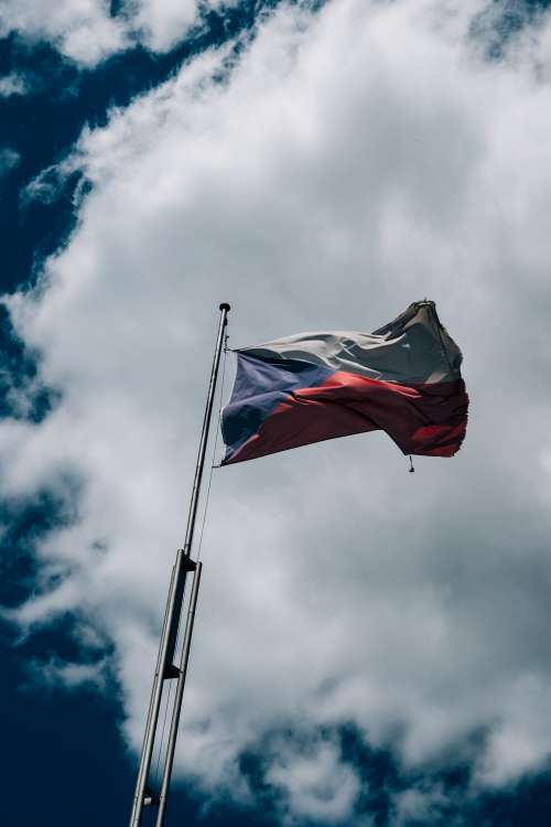 Czech Flag Flies Against A Cloudy Blue Sky Photo