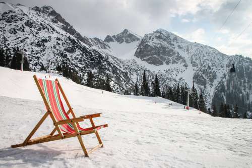 A Beach Chair On Snow Covered Mountain Photo