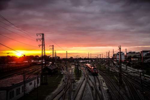 Sunset Over A Hub Of Winding Train Tracks Photo