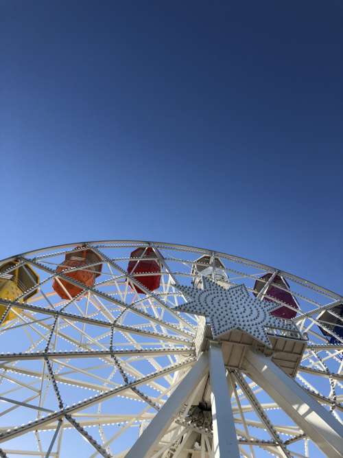Ferris Wheel Against A Blue Sky Photo