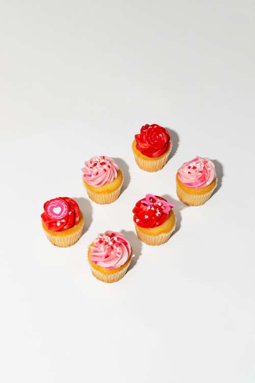 Pink And Red Cupcakes On A White Background Photo