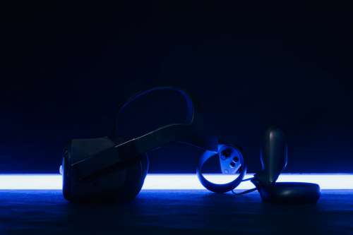 VR Headset And Controllers Backlit By Blue Light Photo