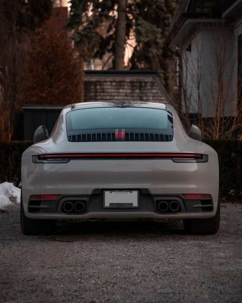 Back Of A Grey Sports Car With Red Detail Photo