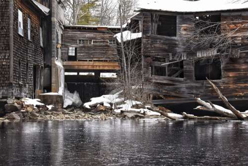 Frozen River Below Collapsed Wooden Building Photo