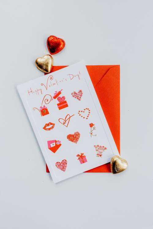 Flatlay Of A Valentines Day Card With Foil Chocolate Hearts Photo