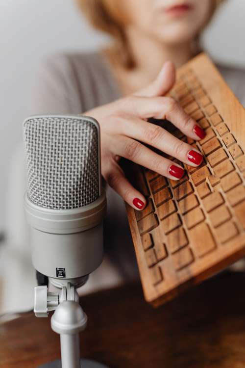 Woman Recording ASMR Sounds On Microphone