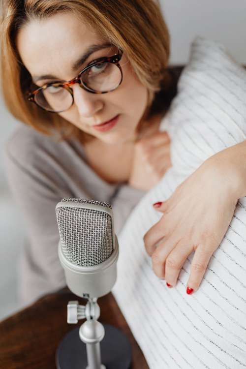 Woman Recording ASMR Sounds On Microphone