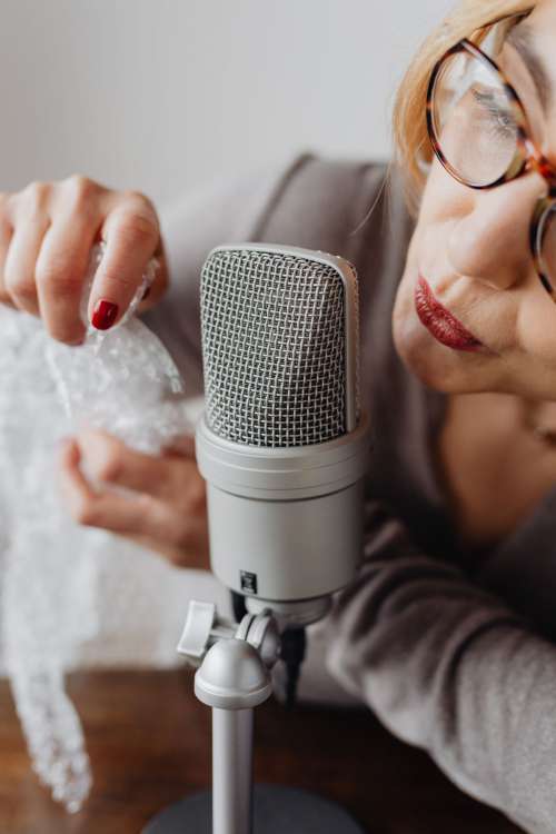 Woman Recording ASMR Sounds On Microphone