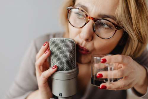 Woman Recording ASMR Sounds On Microphone