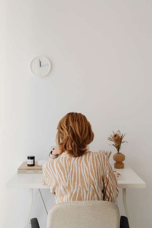 A woman works at her desk - home office