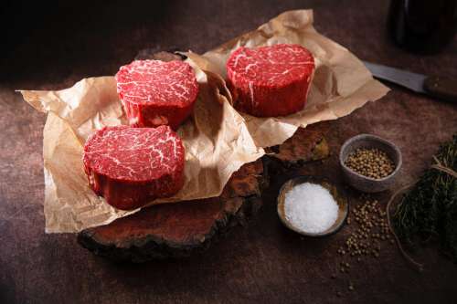 Rounds Of Raw Meat On Butcher Paper Photo