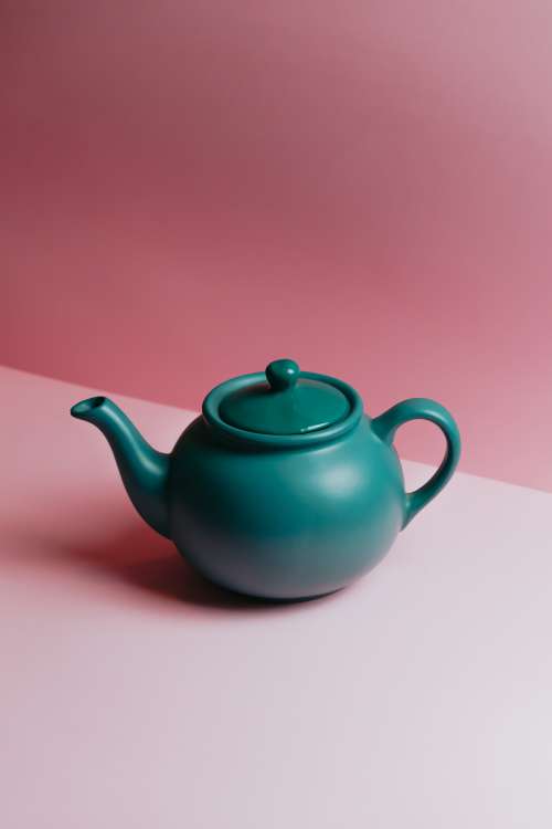 Teapot Against A Lit Pink Background Photo
