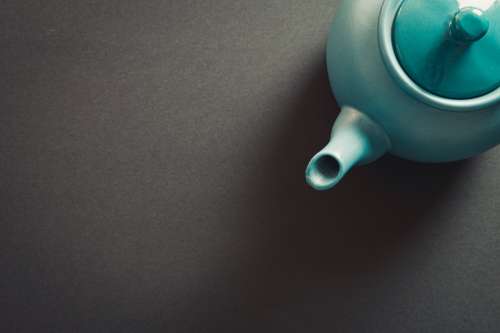 Top View Of A Teapot Against A Grey Background Photo