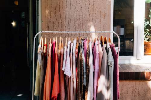 Full Metal Clothing Rack Sits Outside A Shops Entrance Photo