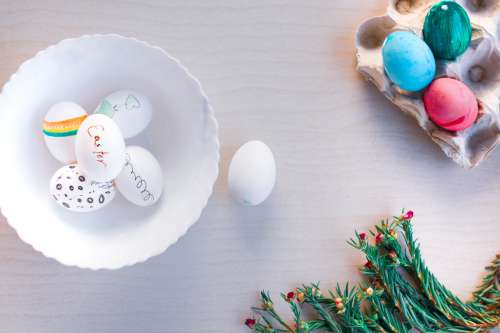 Decorated Easter Eggs In A White Bowl And Egg Carton Photo