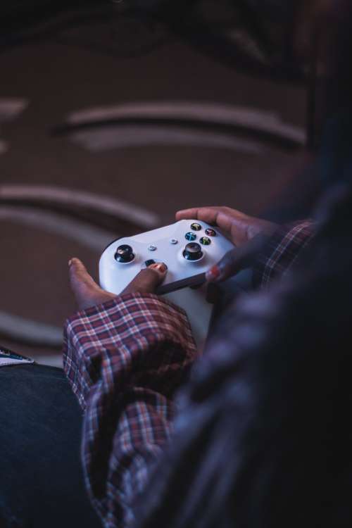 Hands Hold A Video Game Controller Photo