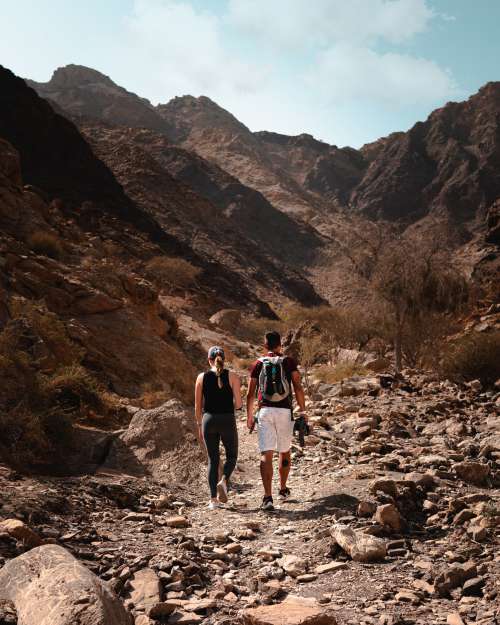 Two People Hiking On A Rustic Trail Photo