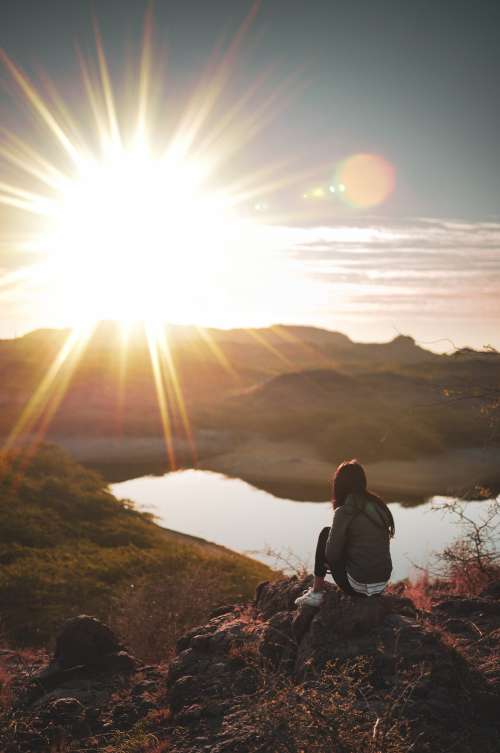 Person Watches The Sunset Over The Distant Mountains Photo