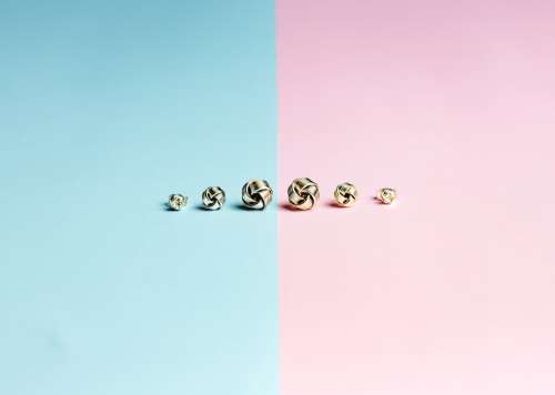 Half Pink Half Blue Background With Stud Earrings In A Row Photo