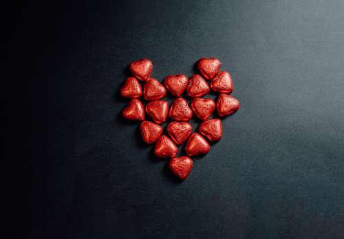 Red Foiled Chocolate Hearts In Shape Of A Heart Photo