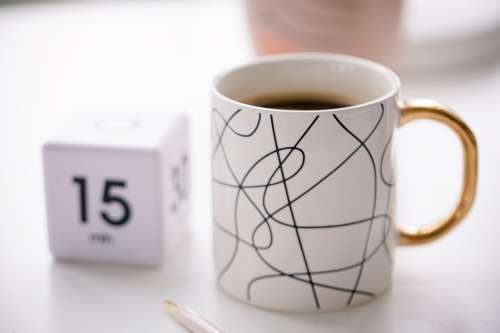 Close Up White Mug Filled With Coffee On A Desk Photo