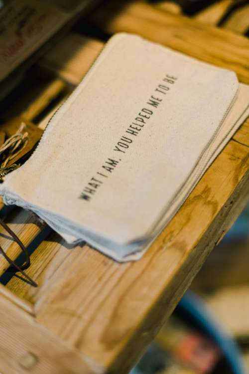 Cloth Bag With Text On A Wooden Shelf Photo