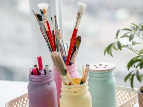 Painted Mason Jars With A Variety Of Craft Supplies Photo