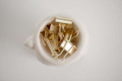 Gold Paper Clips In A White Bowl Photo