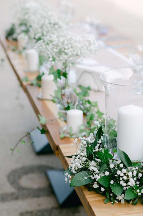 A Line Of White Candle Table Centerpieces Photo