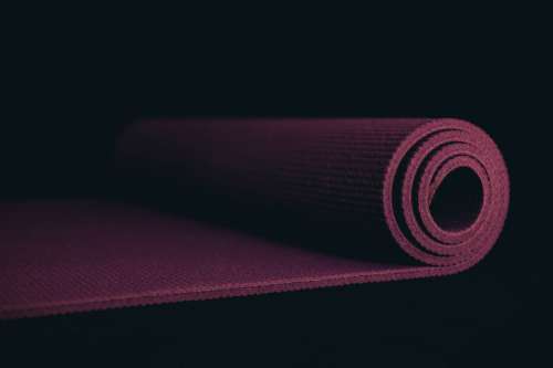 Purple Yoga Mat On A Black Floor Photo