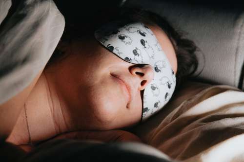 Woman Sleeps Soundly With A Mask Over Her Eyes Photo